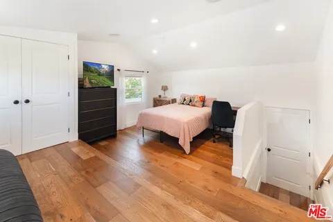 a bedroom with a bed and a view of bedroom