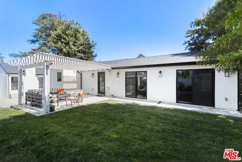 a front view of house with yard and outdoor seating