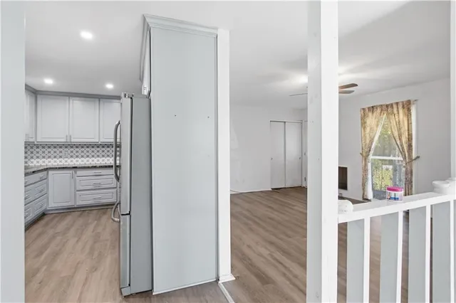 a view of kitchen with furniture and refrigerator