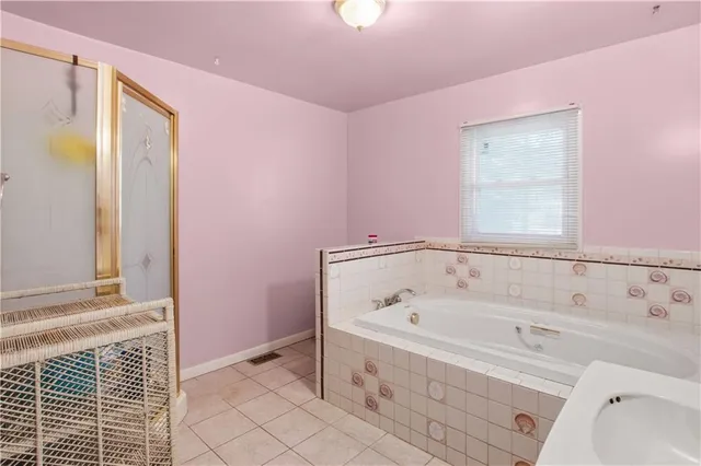 a bathroom with a bathtub and a shower