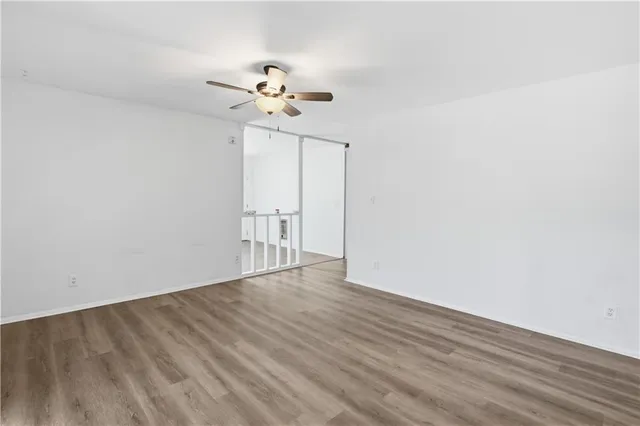 a view of an empty room with wooden floor