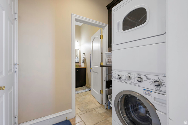 684 North Summit Way Alpine, UT 84004 - Photo 38 of 58 Laundry room with stone tile flooring and stacked washer and dryer