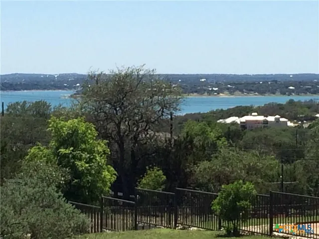 an aerial view of lake and residential houses with outdoor space