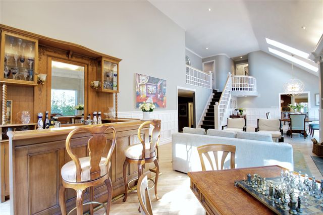 a living room with stainless steel appliances kitchen island granite countertop furniture and a large window