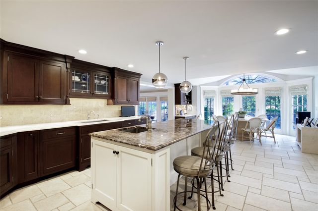 a kitchen with sink cabinets and dining table