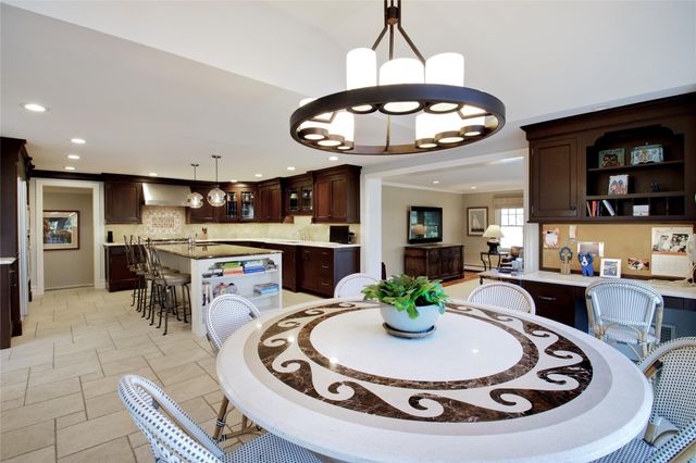 a kitchen with a dining table and chairs