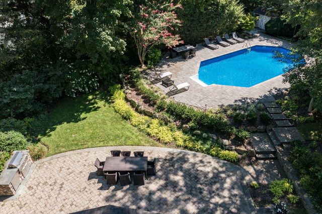an aerial view of a house with a yard and lake view