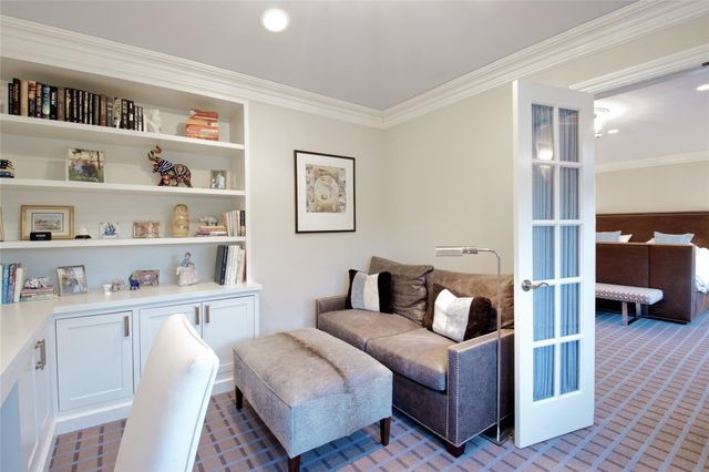 a living room with furniture and a book shelf