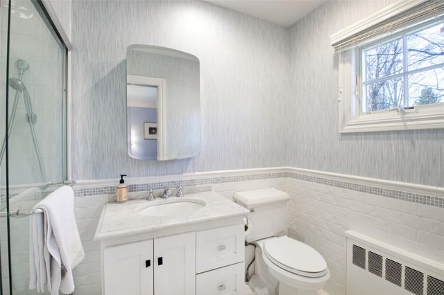 a bathroom with a sink toilet and window