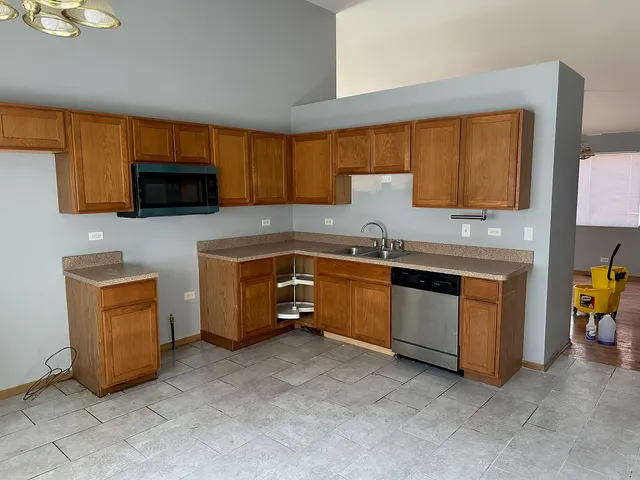 a kitchen with granite countertop a sink and a stove top oven