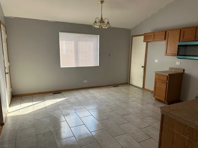 a view of a kitchen with microwave and furniture
