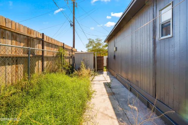 a view of a two chairs in the patio of the house