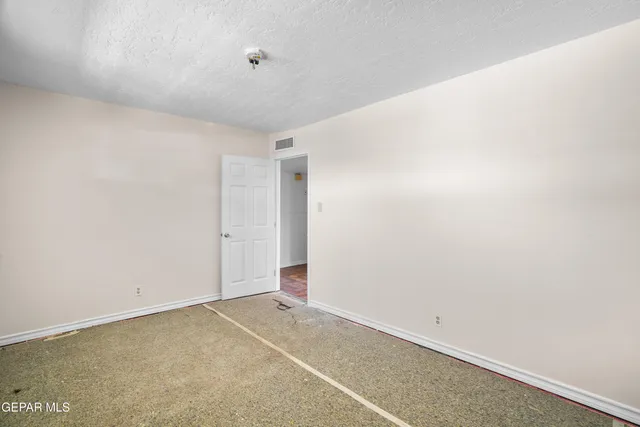 a view of a hallway with a chandelier fan