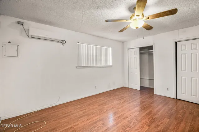 a kitchen with a refrigerator and white cabinets