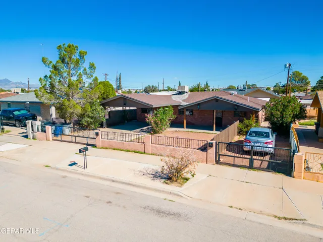 an aerial view of multiple houses with a yard