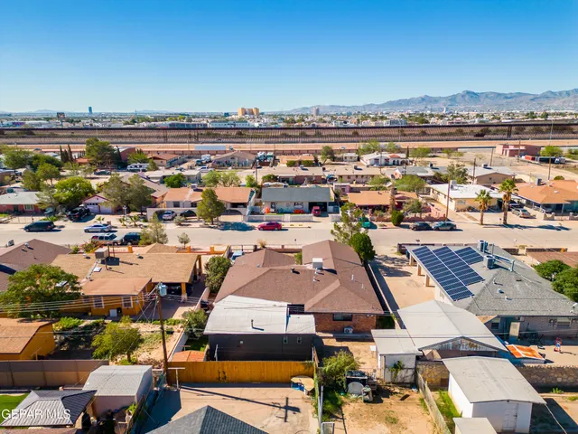an aerial view of a city with ocean view in back