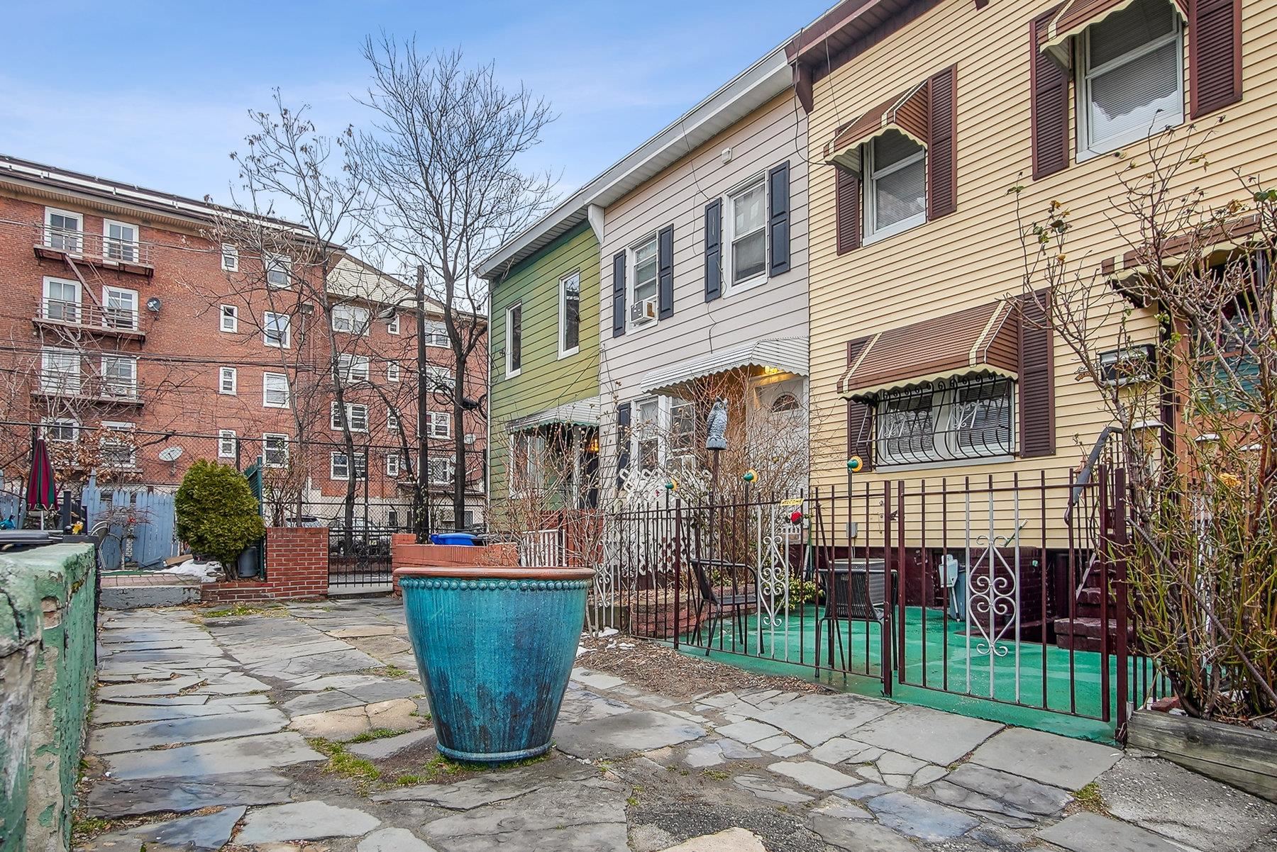 4 Rademan Place Jersey City, NJ 07310 - Photo 2 of 16 a front view of a building with a garden