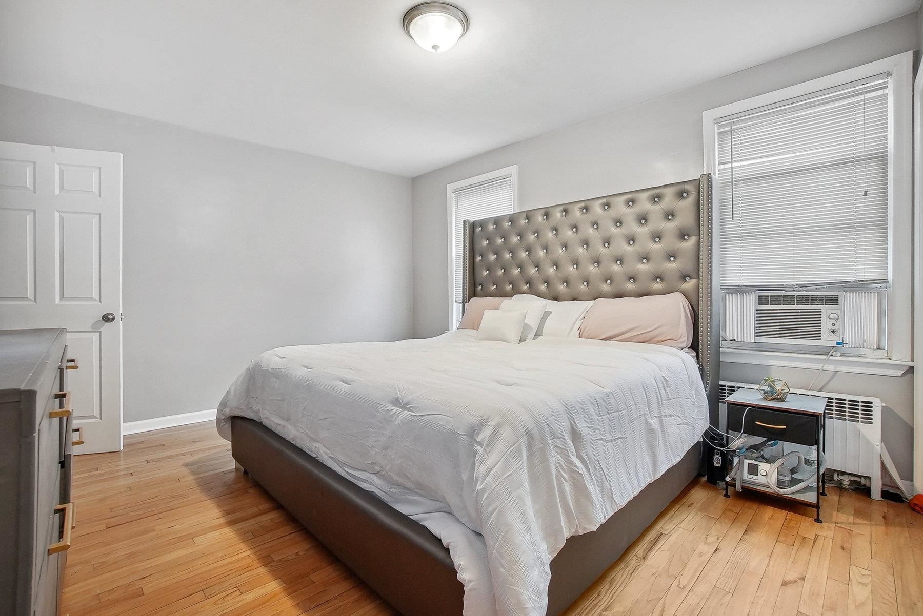 4 Rademan Place Jersey City, NJ 07310 - Photo 4 of 16 a bedroom with a bed and wooden floor
