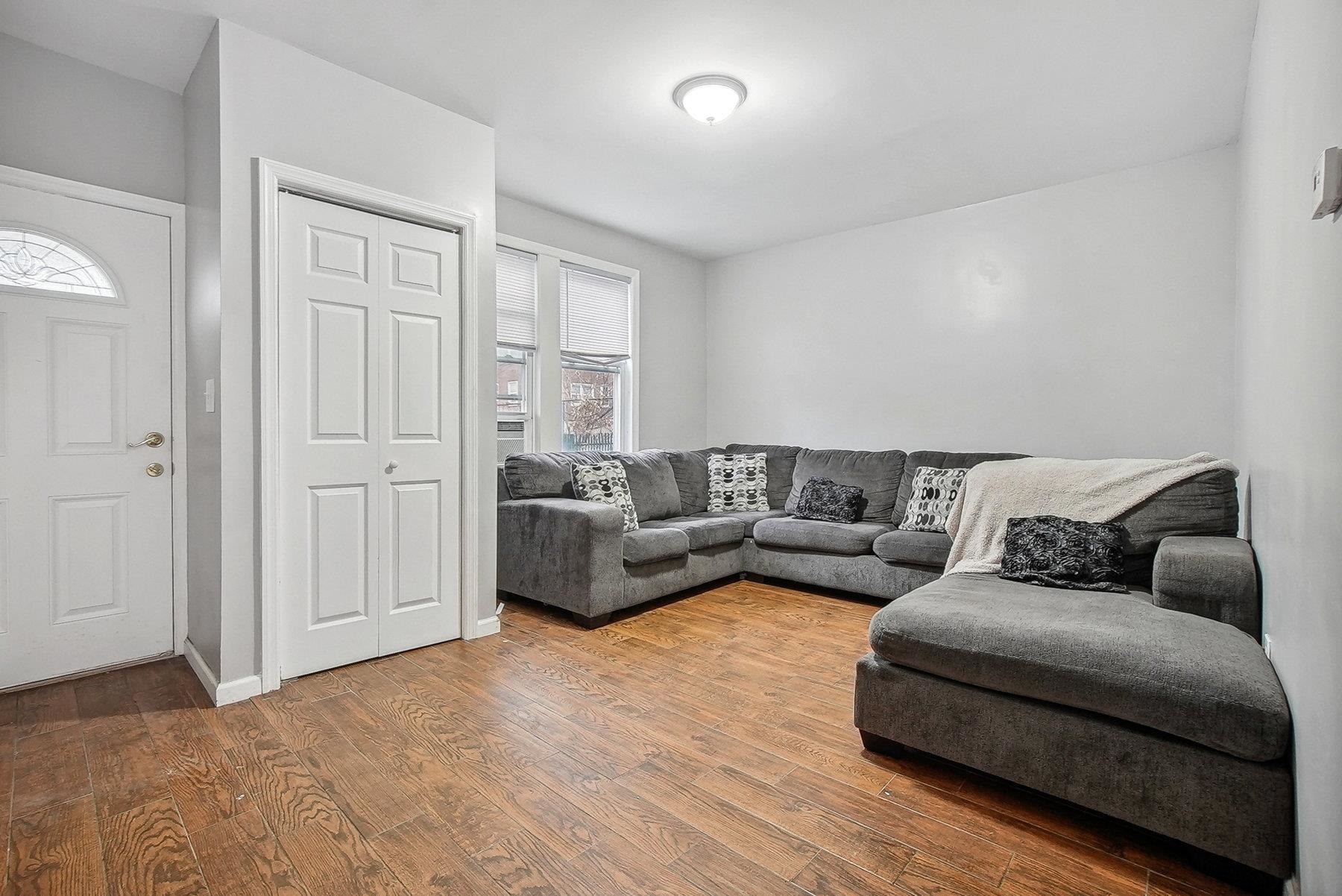4 Rademan Place Jersey City, NJ 07310 - Photo 9 of 16 a living room with furniture and a wooden floor