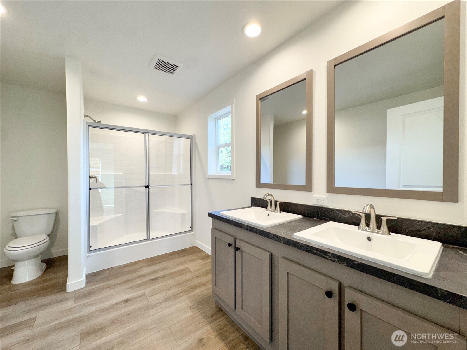 3060 Pennsylvania Street Longview, WA 98632 - Photo 13 of 14 a bathroom with a double vanity sink toilet and a mirror