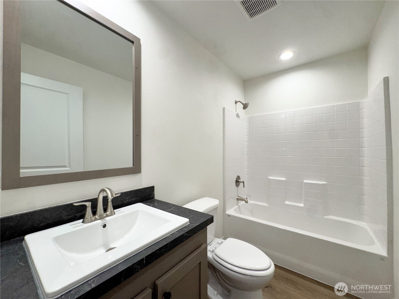 3060 Pennsylvania Street Longview, WA 98632 - Photo 10 of 14 a bathroom with a sink a toilet and a large mirror