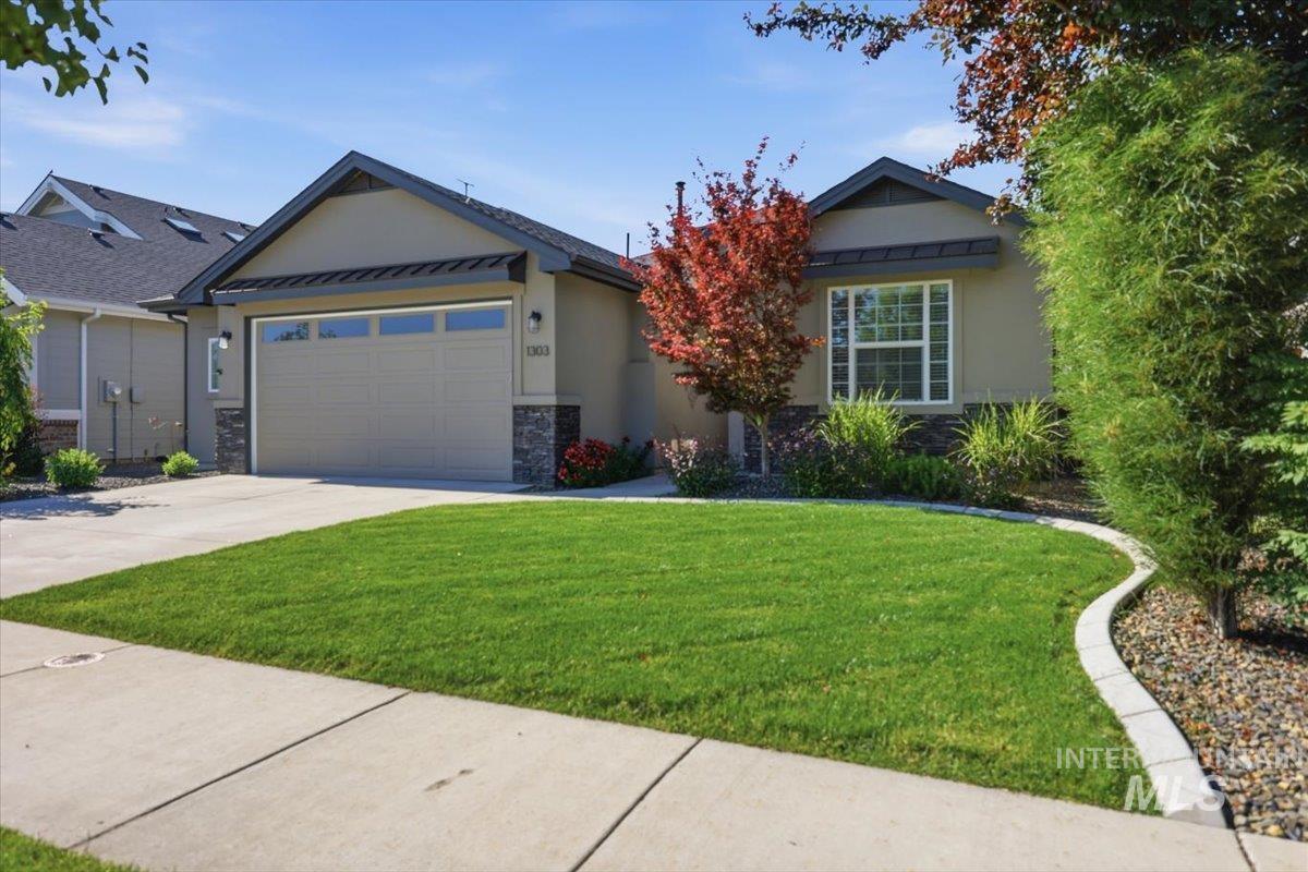 1303 West Brando Street Meridian, ID 83646 - Photo 4 of 49 Single-story residence featuring a two-car garage, stucco exterior, and stone accents