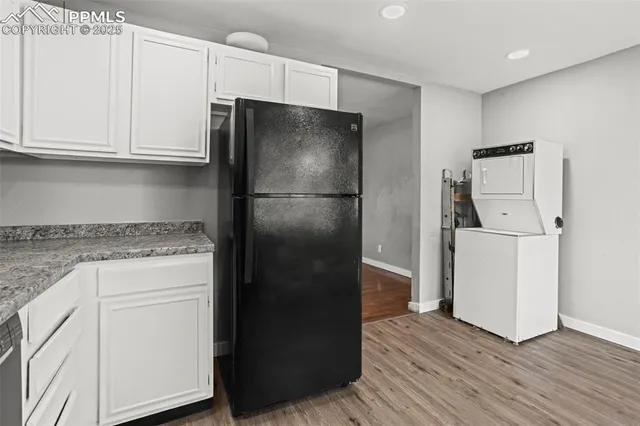 a kitchen with a refrigerator and cabinets