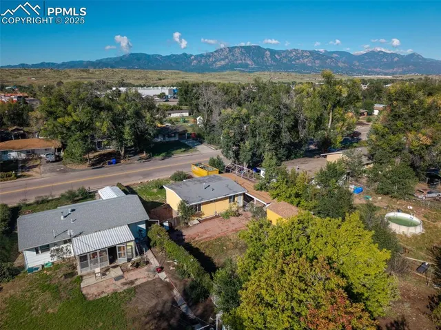 an aerial view of a house with a yard