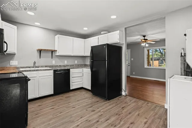 a kitchen with a refrigerator and a sink