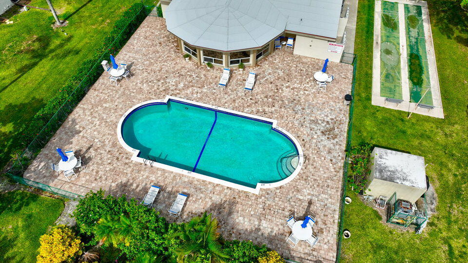 555 Banyan Tree Lane, Unit 302 Delray Beach, FL 33483 - Photo 26 of 69 an aerial view of a house with swimming pool and garden