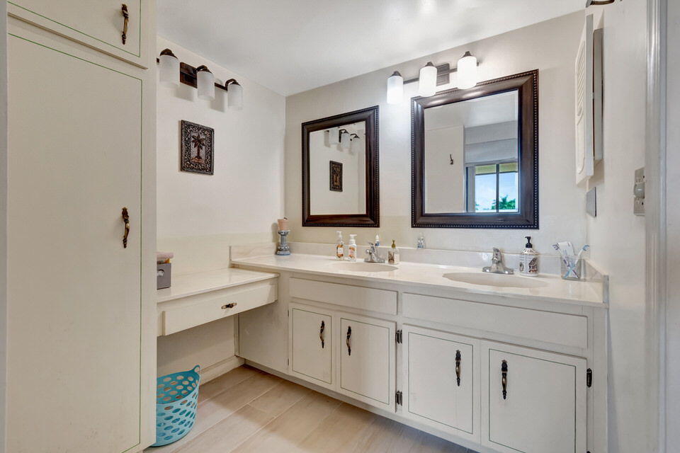 555 Banyan Tree Lane, Unit 302 Delray Beach, FL 33483 - Photo 53 of 69 a bathroom with a double vanity sink mirror and bathtub