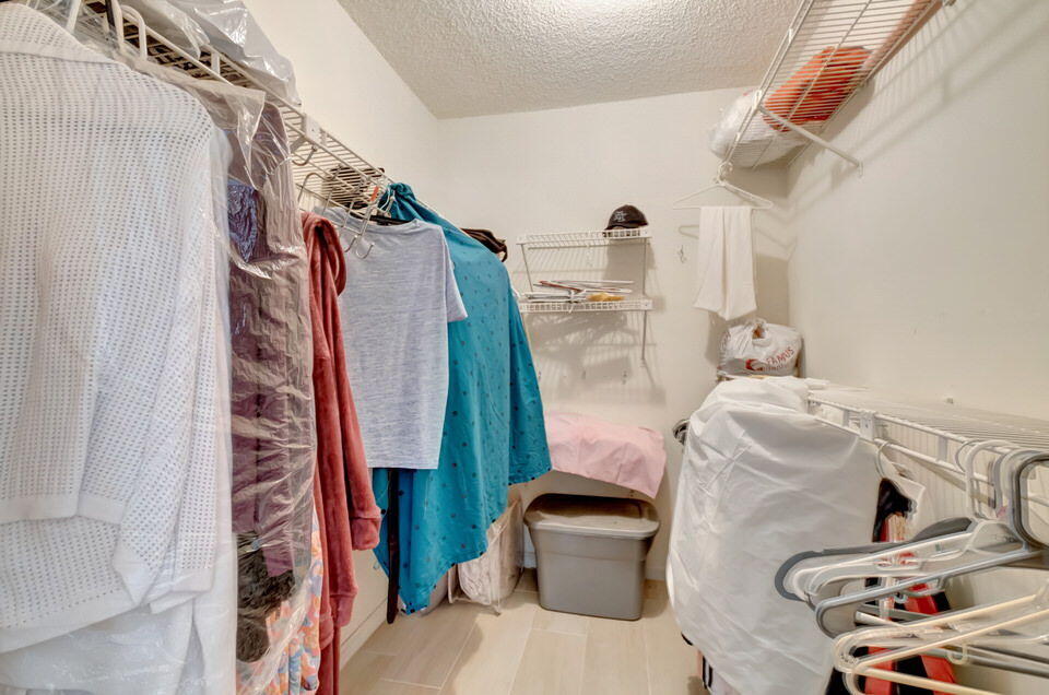 555 Banyan Tree Lane, Unit 302 Delray Beach, FL 33483 - Photo 56 of 69 a view of walk in closet with clothes and shoes