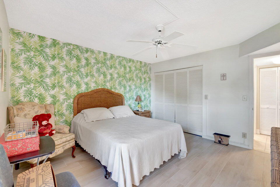 555 Banyan Tree Lane, Unit 302 Delray Beach, FL 33483 - Photo 58 of 69 a bedroom with a bed and a window