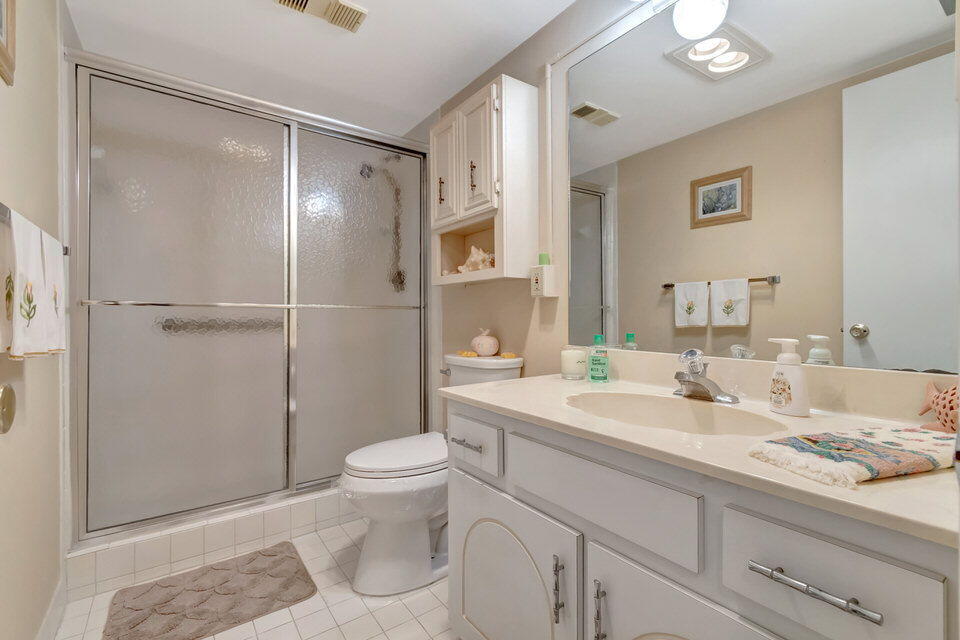 555 Banyan Tree Lane, Unit 302 Delray Beach, FL 33483 - Photo 60 of 69 a spacious bathroom with a granite countertop sink toilet and shower