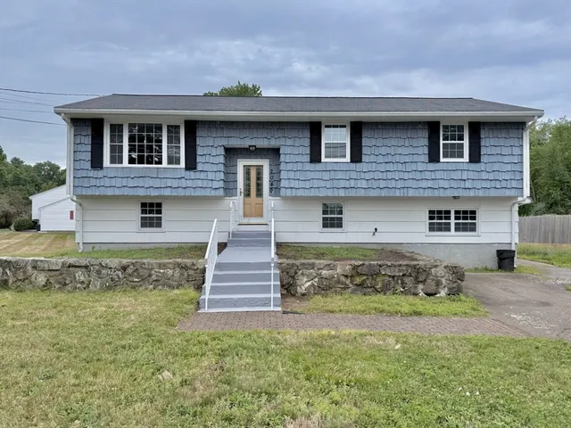 a front view of a house with a yard