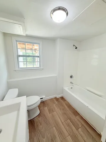 a bathroom with a sink a toilet and bathtub