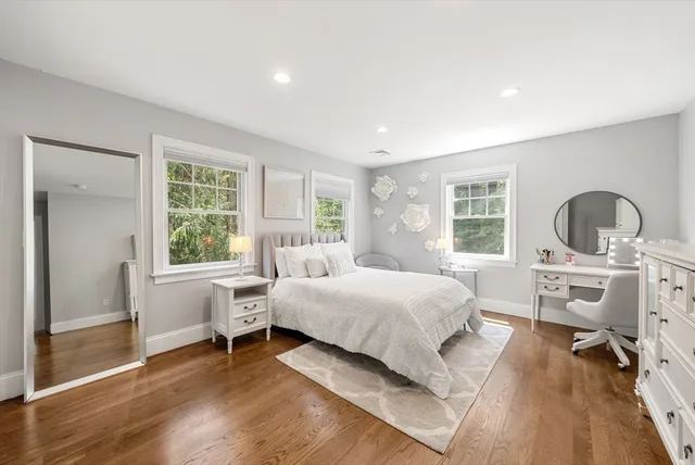 a bathroom with a sink vanity mirror and toilet
