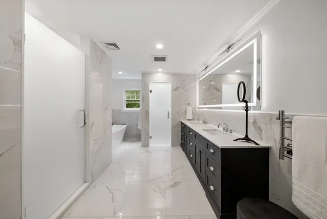 a bathroom with a granite countertop sink a toilet and shower