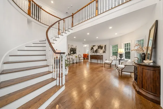 a large white kitchen with granite countertop a white stove top oven and white cabinets