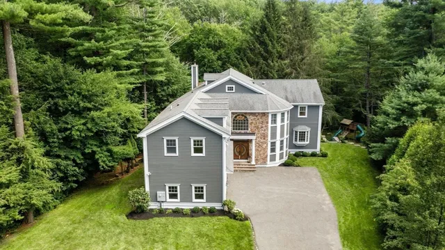a front view of house with yard and green space