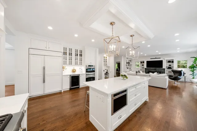 a kitchen with stainless steel appliances white cabinets and a refrigerator