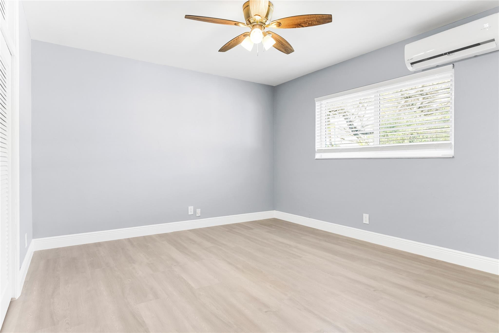 4751 Northeast 21st Terrace, Unit 3 Lighthouse Point, FL 33064 - Photo 16 of 18 an empty room with a window and a ceiling fan