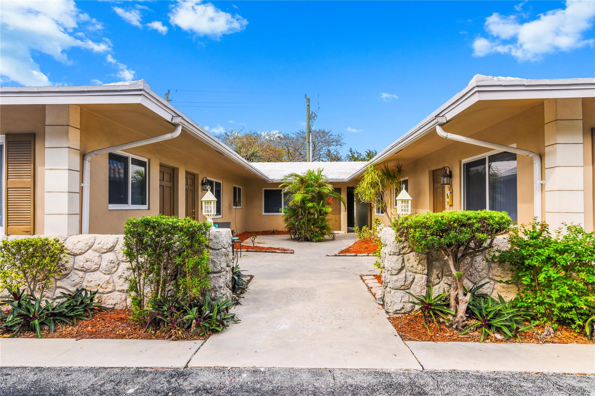 4751 Northeast 21st Terrace, Unit 3 Lighthouse Point, FL 33064 - Photo 2 of 18 a front view of a house with a yard