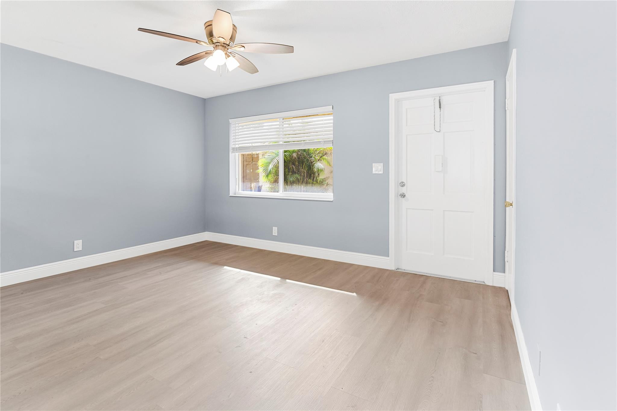 4751 Northeast 21st Terrace, Unit 3 Lighthouse Point, FL 33064 - Photo 4 of 18 an empty room with windows and fan