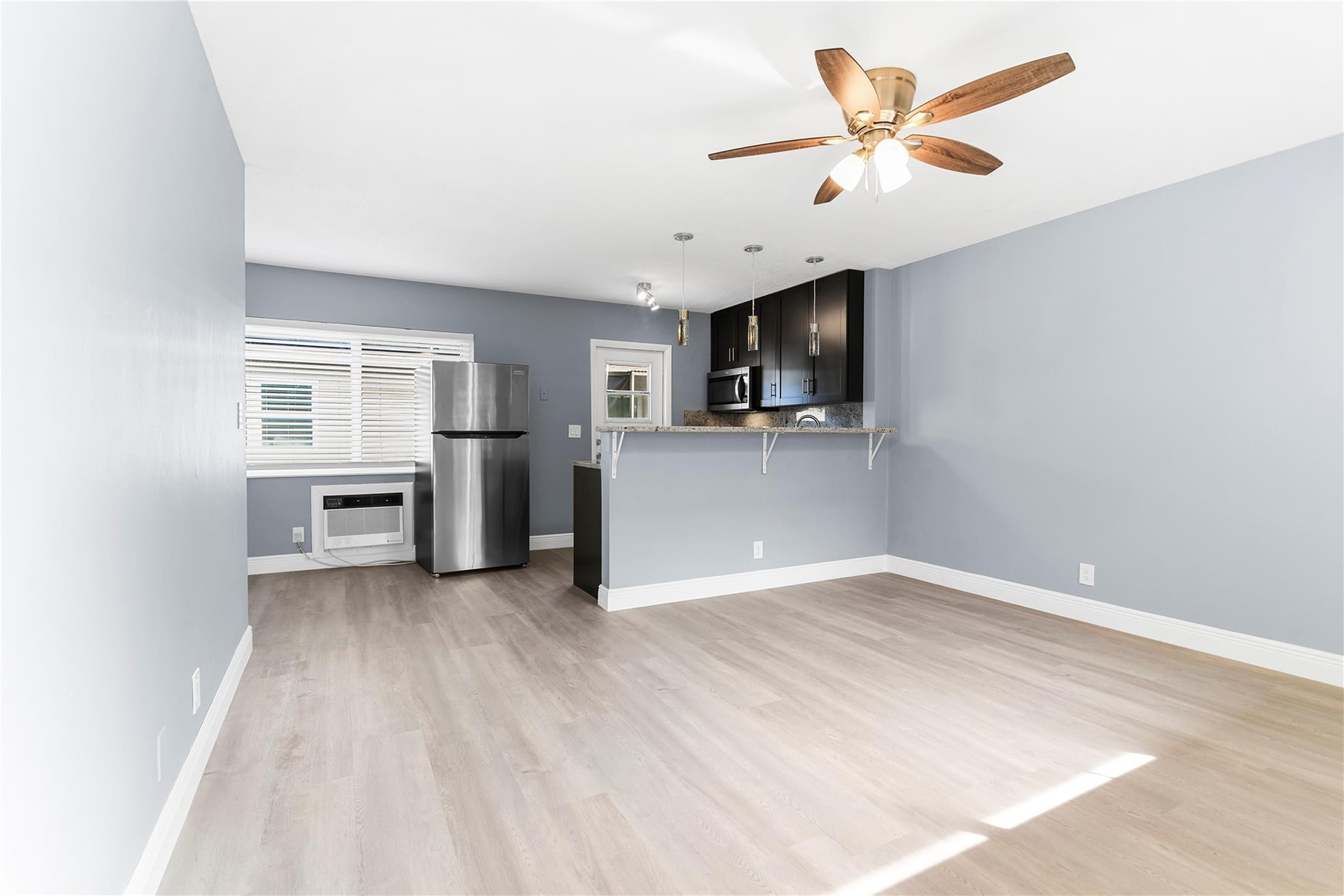 4751 Northeast 21st Terrace, Unit 3 Lighthouse Point, FL 33064 - Photo 5 of 18 a view of a kitchen with a sink dishwasher oven and a refrigerator