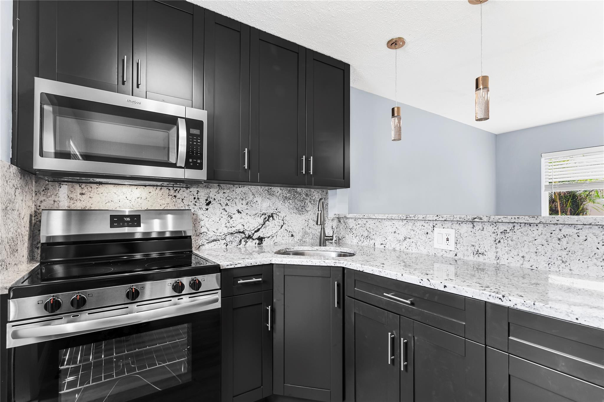 4751 Northeast 21st Terrace, Unit 3 Lighthouse Point, FL 33064 - Photo 6 of 18 a kitchen with a sink stove and microwave