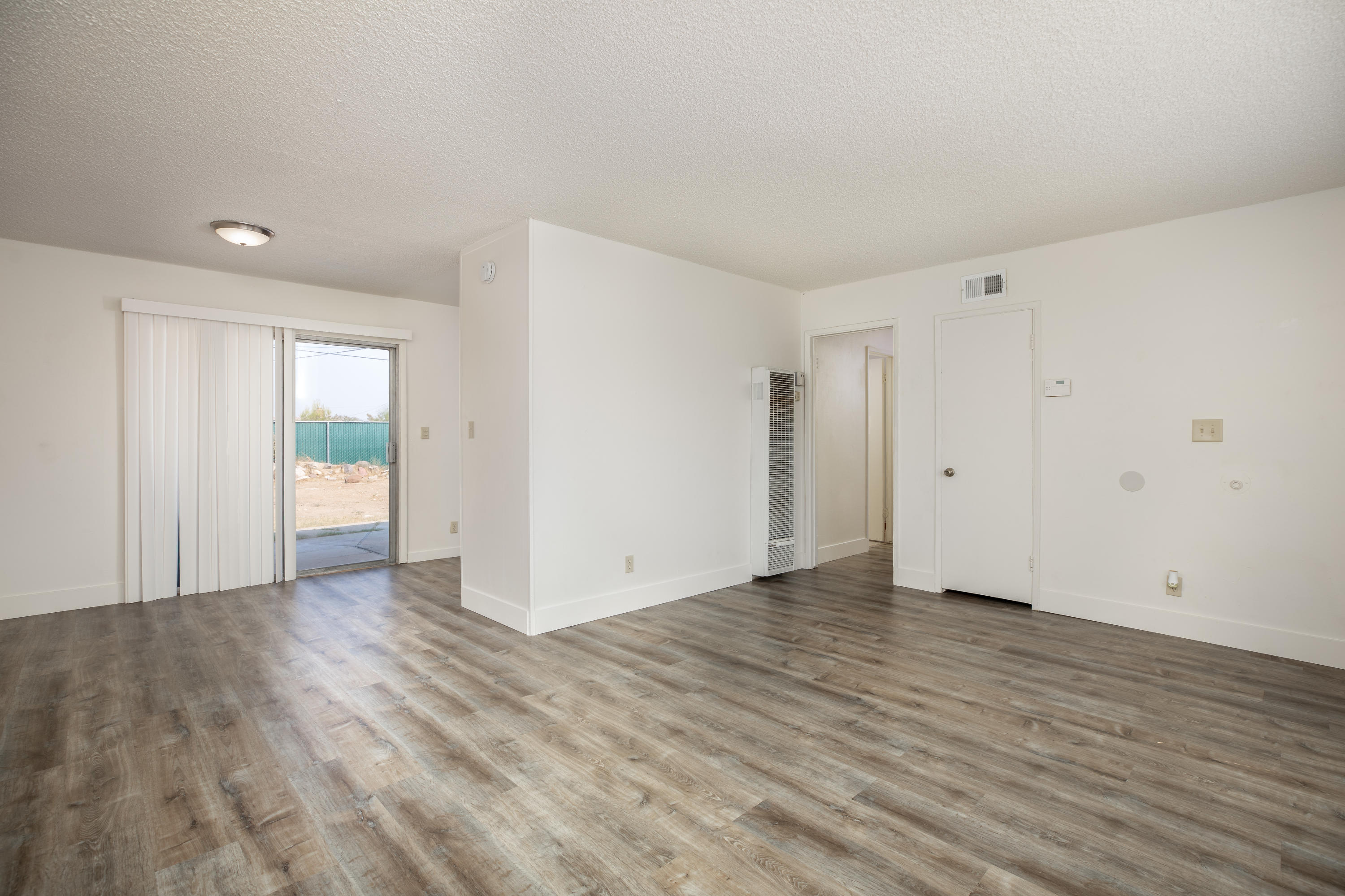 248 North Norma Street Ridgecrest, CA 93555 - Photo 4 of 17 a view of an empty room with wooden floor