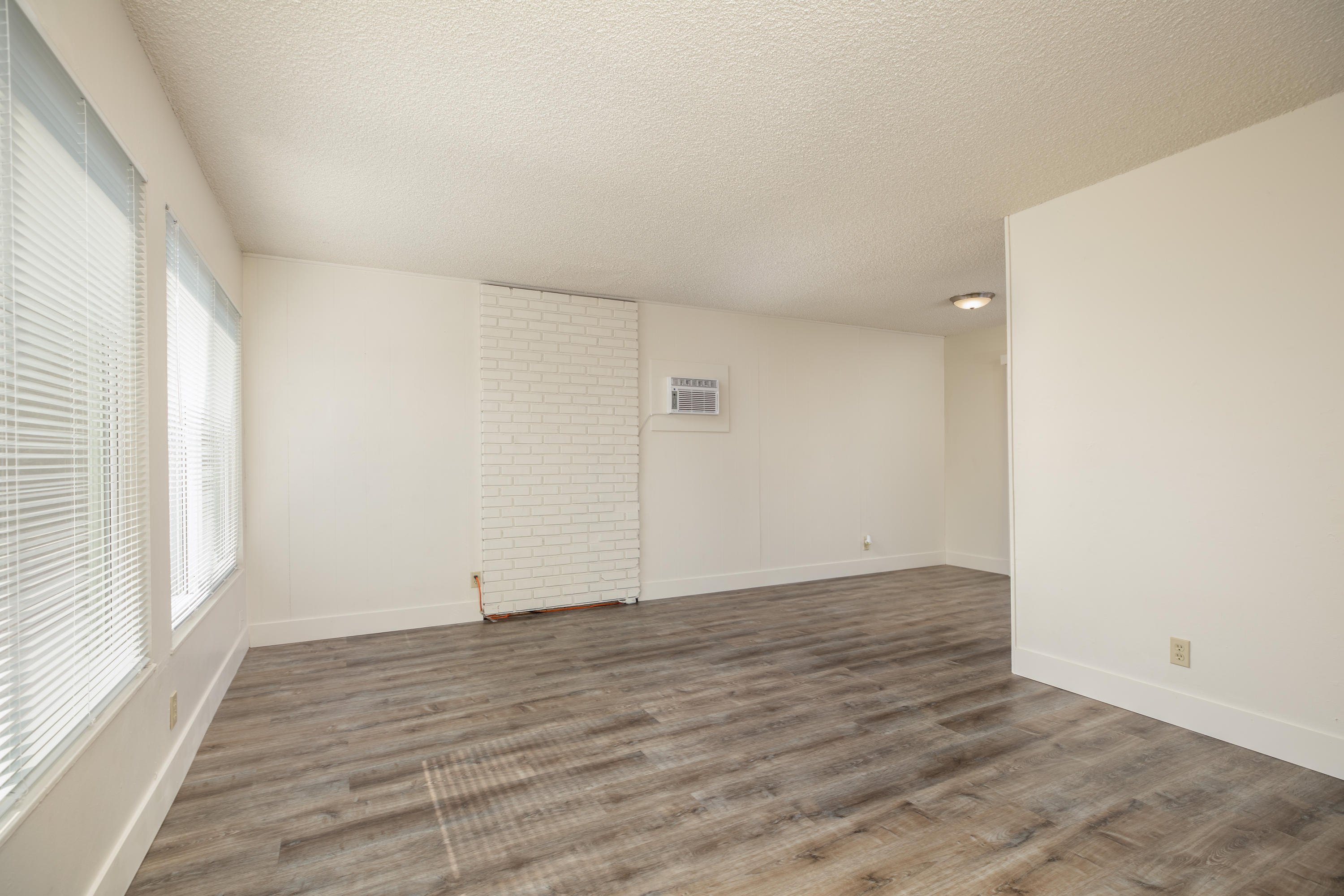 248 North Norma Street Ridgecrest, CA 93555 - Photo 5 of 17 a view of an empty room with wooden floor and a window