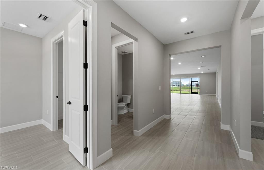 42533 Little Ridge Road Punta Gorda, FL 33982 - Photo 11 of 50 a view of a hallway with wooden floor and a glass door