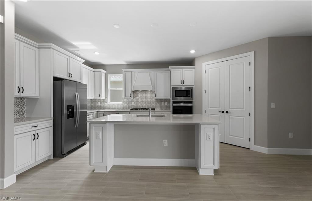 42533 Little Ridge Road Punta Gorda, FL 33982 - Photo 26 of 50 a kitchen with stainless steel appliances a refrigerator sink and cabinets